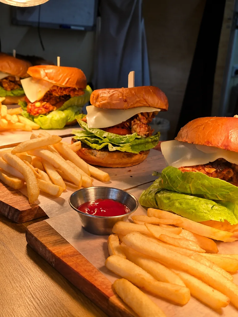 Burgers and fries served on wooden boards
