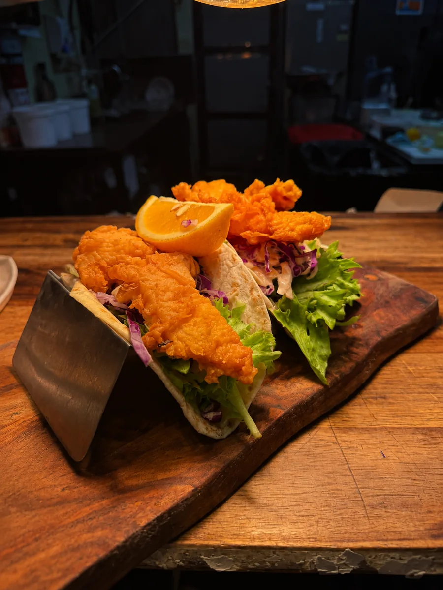 A crispy wrap with golden fried filling and salad