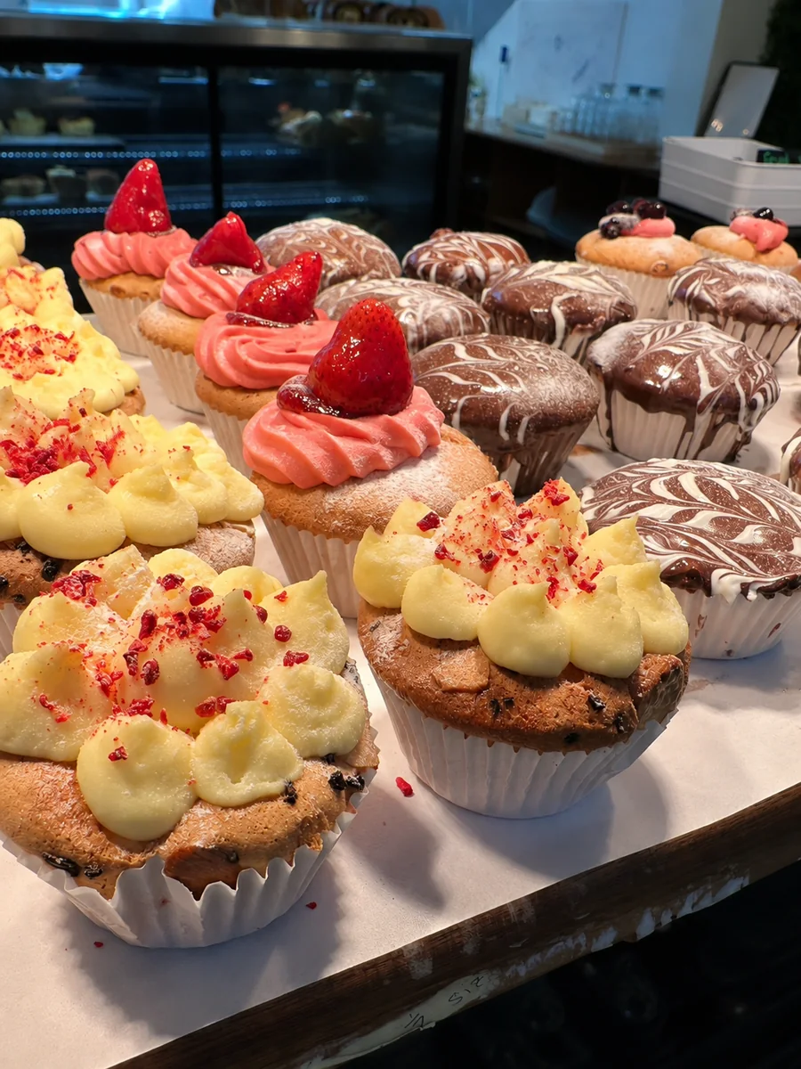 Freshly baked iced cupcakes and pastries